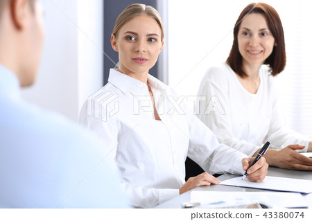 Group of business people or lawyers discussing terms of transaction in office. Meeting and teamwor Group of business people or lawyers discussing terms of transaction in office. Meeting and teamwor 43380074