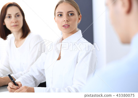 Group of business people or lawyers discussing terms of transaction in office. Meeting and teamwor Group of business people or lawyers discussing terms of transaction in office. Meeting and teamwor 43380075