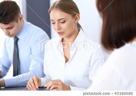 Group of business people or lawyers discussing terms of transaction in office. Meeting and teamwor Group of business people or lawyers discussing terms of transaction in office. Meeting and teamwor 43380080