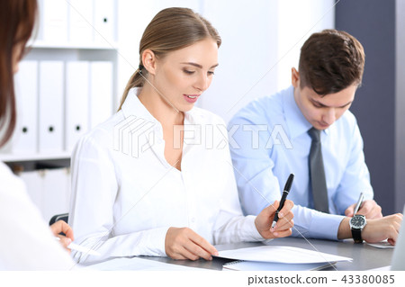 Group of business people or lawyers discussing terms of transaction in office. Meeting and teamwor Group of business people or lawyers discussing terms of transaction in office. Meeting and teamwor 43380085