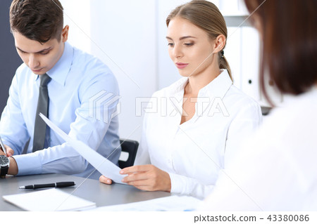 Group of business people or lawyers discussing terms of transaction in office. Meeting and teamwor Group of business people or lawyers discussing terms of transaction in office. Meeting and teamwor 43380086
