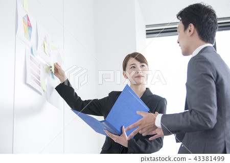Male and female office workers meeting in a company Male and female office workers meeting in a company 43381499