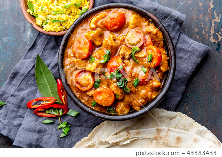 INDIAN FOOD. ROGAN JOSH curry sauce. Pork rogan josh with rice and naan bread 43383433