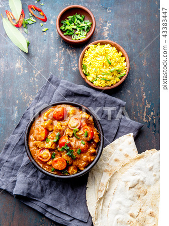 INDIAN FOOD. ROGAN JOSH curry sauce. Pork rogan josh with rice and naan bread 43383447