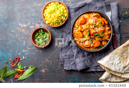 INDIAN FOOD. ROGAN JOSH curry sauce. Pork rogan josh with rice and naan bread 43383449