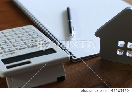 Woman making calculations of home purchase Woman making calculations of home purchase 43385480