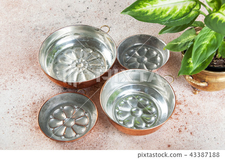 Vintage copper molds on a concrete background. Vintage copper molds on a concrete background. 43387188