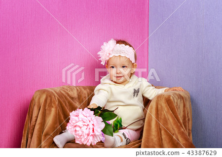 Little girl in the chair with flowers Little girl in the chair with flowers 43387629