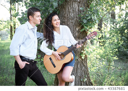 young couple walking in the forest  43387681