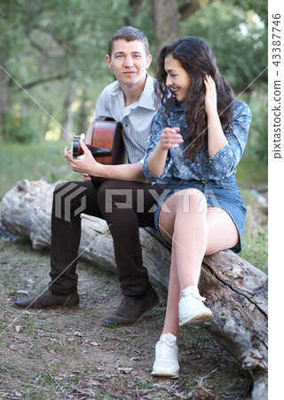 young couple walking in the forest young couple walking in the forest 43387746