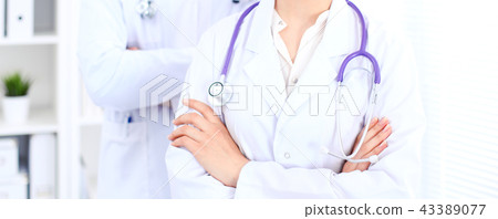 Unknown female doctor with medical staff  at hospital. Teamwork in medicine 43389077