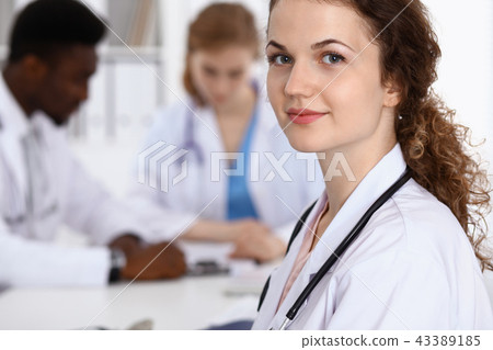 Happy doctor woman with medical staff at the hospital Happy doctor woman with medical staff at the hospital 43389185