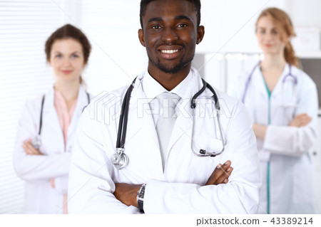 Happy african american male doctor  with medical staff at the hospital. Medicine concept 43389214