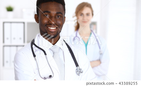 Happy african american male doctor  with medical staff at the hospital. Medicine concept 43389255
