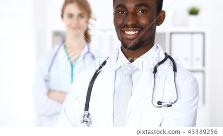 Happy african american male doctor  with medical staff at the hospital. Medicine concept 43389256