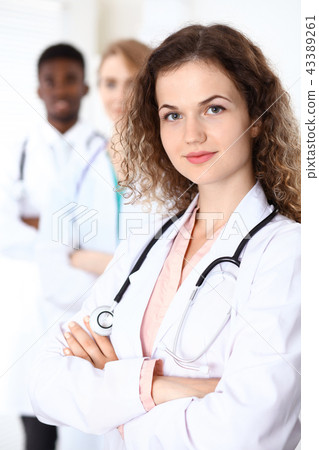 Happy doctor woman  with medical staff at the hospital 43389261