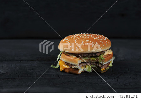 bitten burger on a dark rustic bitten burger on a dark rustic 43391171