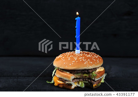 bitten burger with a candle with fire bitten burger with a candle with fire 43391177