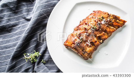 Grilled barbecue pork ribs in a white plate. 43393300