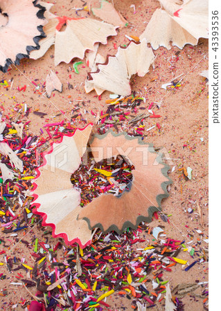Colorful pencil shavings on brown background Colorful pencil shavings on brown background 43393536