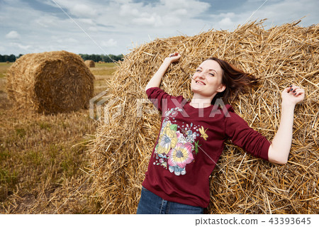 young girl having fun in field with haystack young girl having fun in field with haystack 43393645