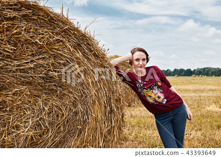 young girl having fun in field with haystack young girl having fun in field with haystack 43393649