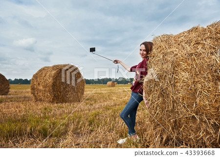 young girl having fun in field with haystack young girl having fun in field with haystack 43393668