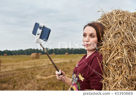 young girl having fun in field with haystack 43393669