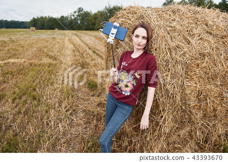 young girl having fun in field with haystack 43393670