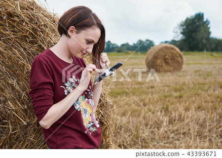 young girl having fun in field with haystack 43393671