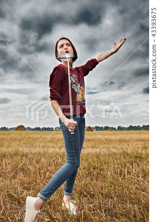 young girl having fun in field with haystack 43393675