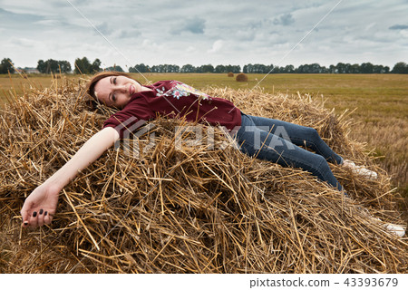 young girl having fun in field with haystack 43393679