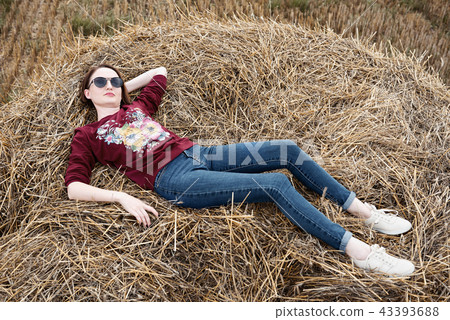 young girl having fun in field with haystack 43393688