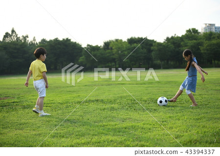 Two children playing soccer 43394337