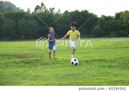 Two children playing soccer Two children playing soccer 43394342