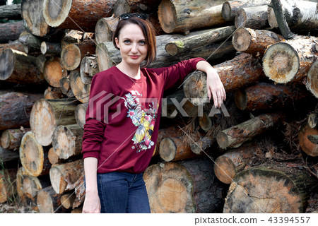 young girl having fun in forest, posing near logs 43394557