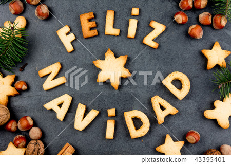 FELIZ NAVIDAD COOKIES. Words Merry Christmas en Spanish with baked cookies, Christmas decoration and 43395401