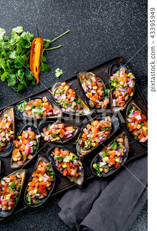 PERUVIAN FOOD. Choros a la chalaca. Big mussels, choros zapatos seasoned with purple onion, tomatoes 43395949