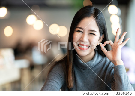 Portrait of young attractive asian woman looking a Portrait of young attractive asian woman looking a 43396149
