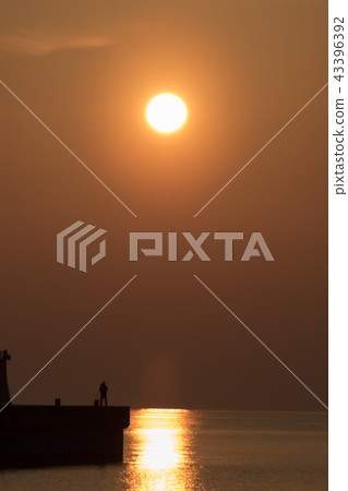 fishing and photographer with sunrise 43396392