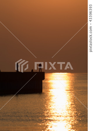 fishing and photographer with sunrise 43396393