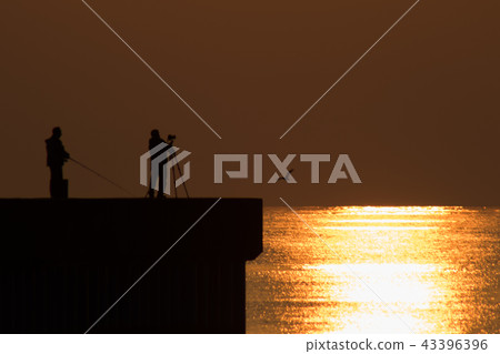 fishing and photographer with sunrise 43396396