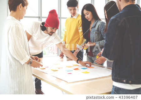 Multiethnic creative team working together Multiethnic creative team working together 43396407