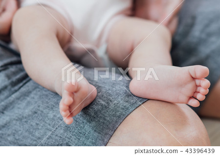 Couple hands and baby feet Couple hands and baby feet 43396439