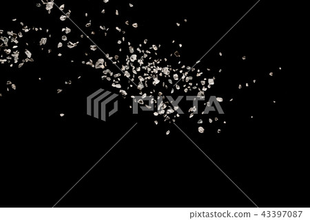 Split debris of stone exploding against black. 43397087