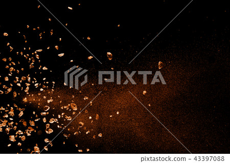 Split debris of stone exploding against black. 43397088