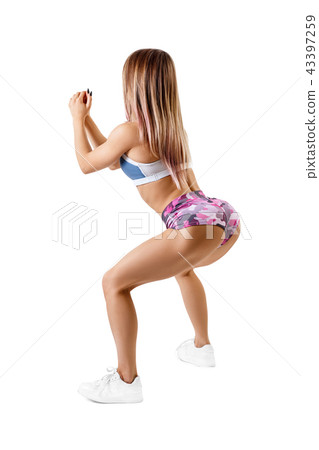 Young girl in sportswear doing squats workout. Young girl in sportswear doing squats workout. 43397259
