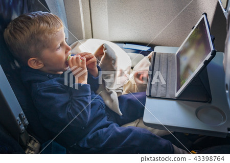 Baby boy is sitting on the plane 43398764