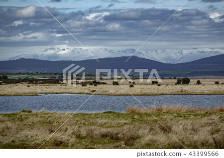 Lake and different levels of mountains with clouds 43399566