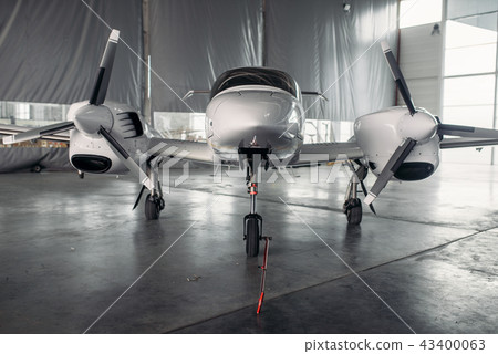 Private turbo-propeller airplane in hangar, nobody 43400063